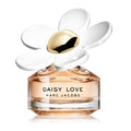 A glass bottle of 'Daisy Love' eau de toilette by Marc Jacobs with a white flower decor on the top.