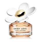 A glass bottle of 'Daisy Love' eau de toilette by Marc Jacobs with a white flower decor on the top.