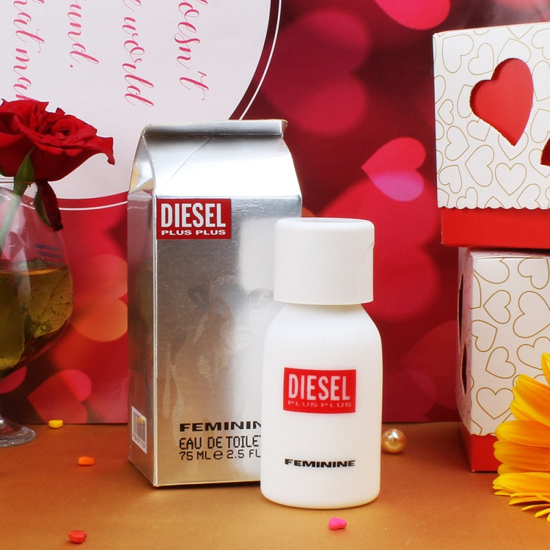 Diesel perfume bottle and packaging on a festive background with red roses and heart shapes.