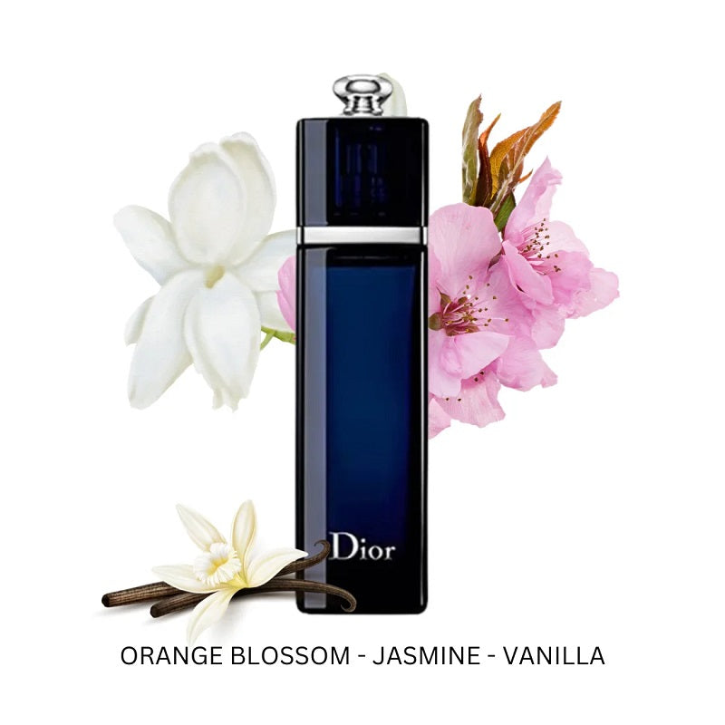 Dior perfume bottle with flowers and vanilla beans on a white background