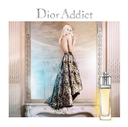Dior Addict perfume advertisement with a woman in an elegant dress and a bottle of perfume.