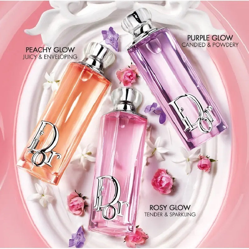 Three perfume bottles labeled 'Peachy Glow', 'Rosy Glow', and 'Purple Glow' on a decorative plate with flowers.