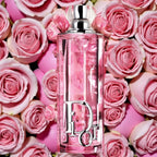 Dior perfume bottle surrounded by pink roses