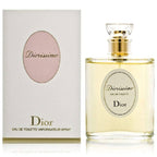 A bottle and box of Diorissimo Eau De Toilette by Christian Dior. The bottle is clear with a gold cap, and the box has a soft pink tone with the Dior logo.