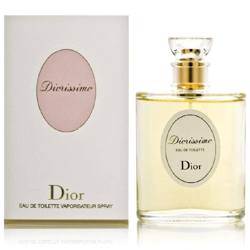 A bottle and box of Diorissimo Eau De Toilette by Christian Dior. The bottle is clear with a gold cap, and the box has a soft pink tone with the Dior logo.