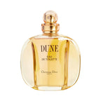 A curved glass bottle of Dune Eau de Toilette by Christian Dior with a gold cap.