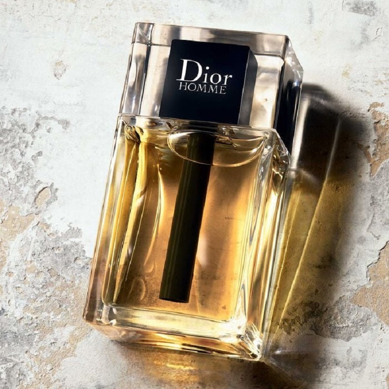Dior Homme perfume bottle on a textured surface