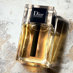 Dior Homme perfume bottle on a textured surface