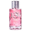 A glass bottle of Dior Joy Intense Eau de Parfum with a pink liquid visible and the brand name 'Dior' displayed on the bottle.