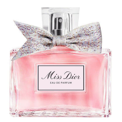 Miss Dior Eau de Parfum bottle with a decorative bow on a white background