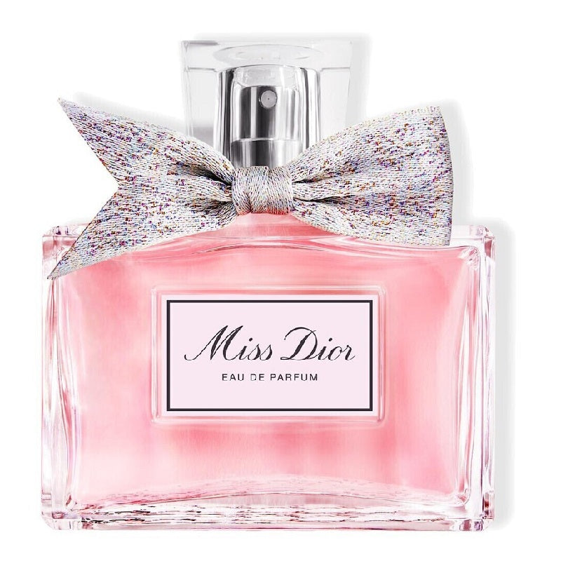 Miss Dior Eau de Parfum bottle with a decorative bow on a white background