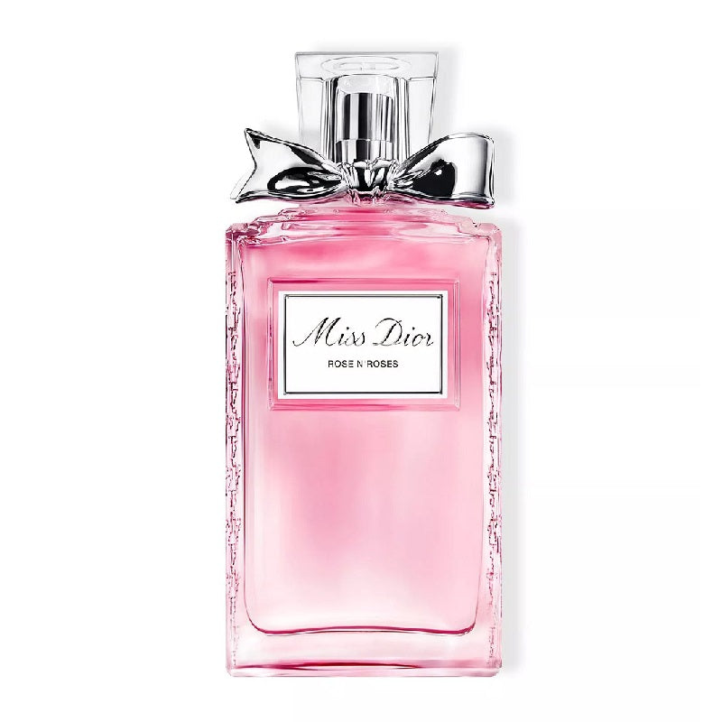 Pink Dior perfume bottle with a bow on a white background