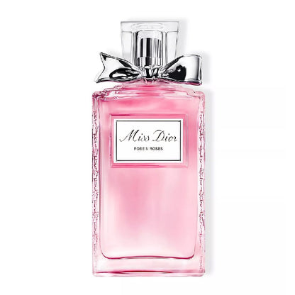 Pink Dior perfume bottle with a bow on a white background