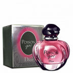 A bottle of 'Poison Girl' eau de parfum by Dior with a pink label and cap, alongside its green box packaging.