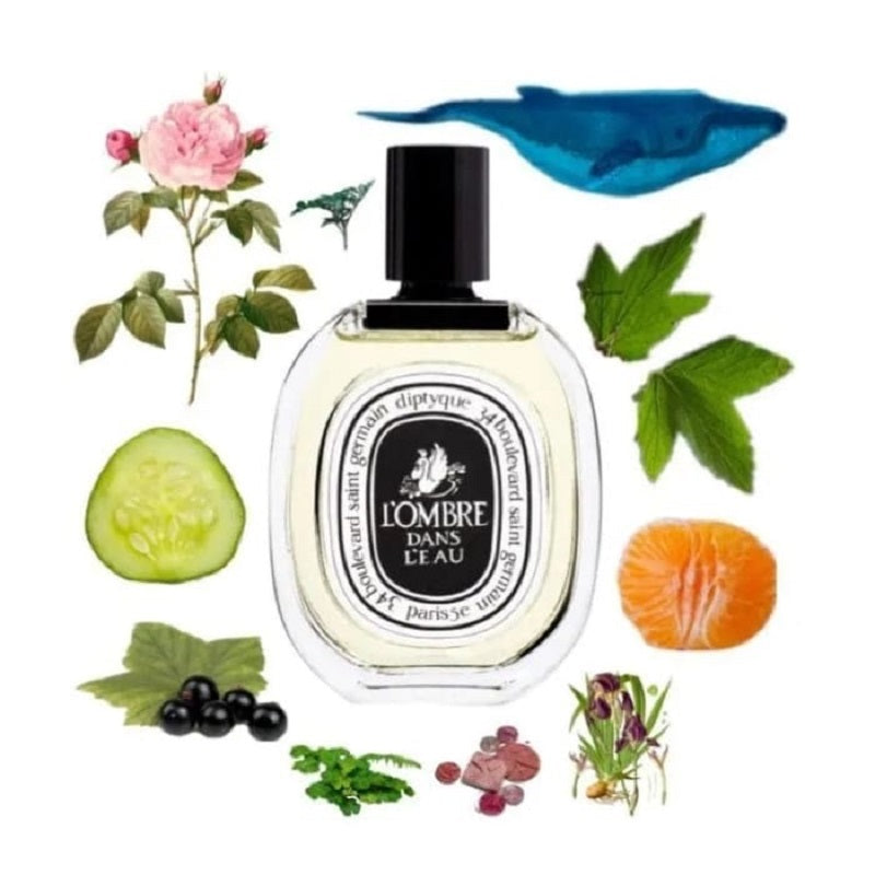 Diptyque perfume bottle surrounded by natural elements like flowers, leaves, and fruits on a white background