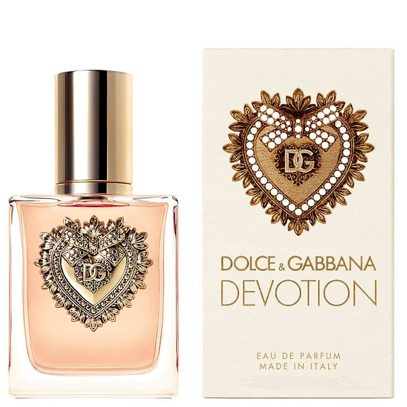 A product image featuring a 100ml bottle of Dolce Devotion Eau de Parfum by Dolce & Gabbana, alongside its packaging which showcases the brand's logo and the scent name in a decorative heart shape.