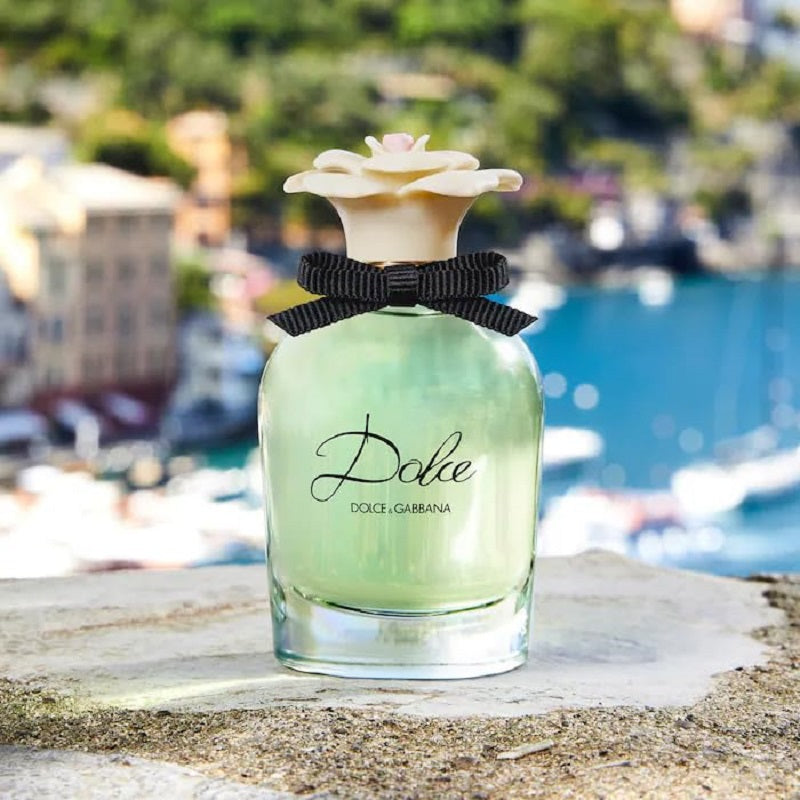 Dolce & Gabbana perfume bottle with a scenic background