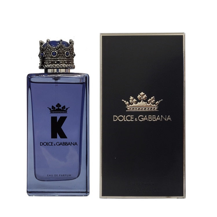 A bottle of Dolce K-King Eau de Parfum by Dolce Gabbana, with a black and blue color scheme, alongside its packaging box.