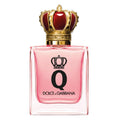 A glass bottle of Dolce Q-Queen eau de parfum by Dolce Gabbana with a pink liquid visible and a gold crown on the cap.