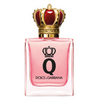 A glass bottle of Dolce Q-Queen eau de parfum by Dolce Gabbana with a pink liquid visible and a gold crown on the cap.