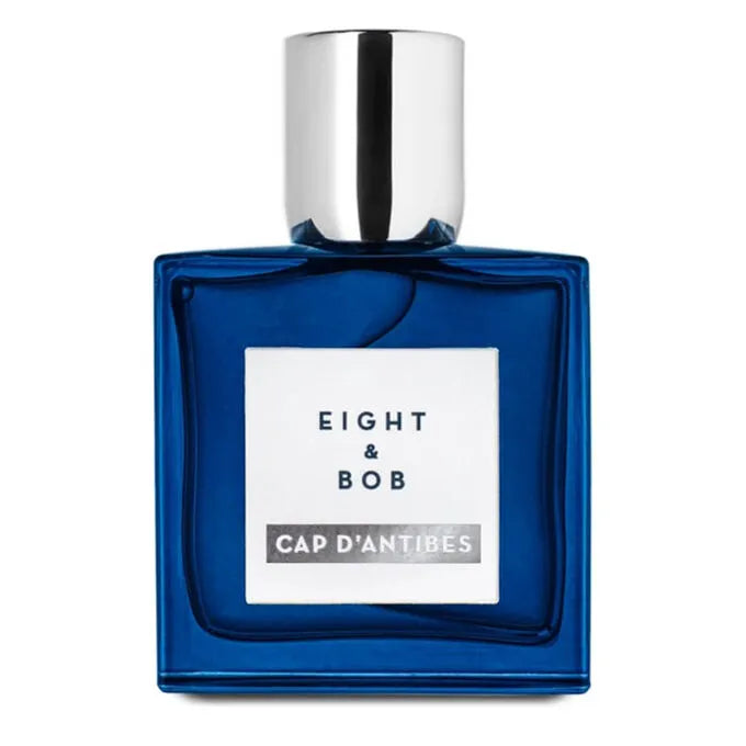 Blue perfume bottle with silver cap on a white background