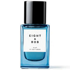 Blue perfume bottle with black cap labeled 'Eight & Bob' on a white background