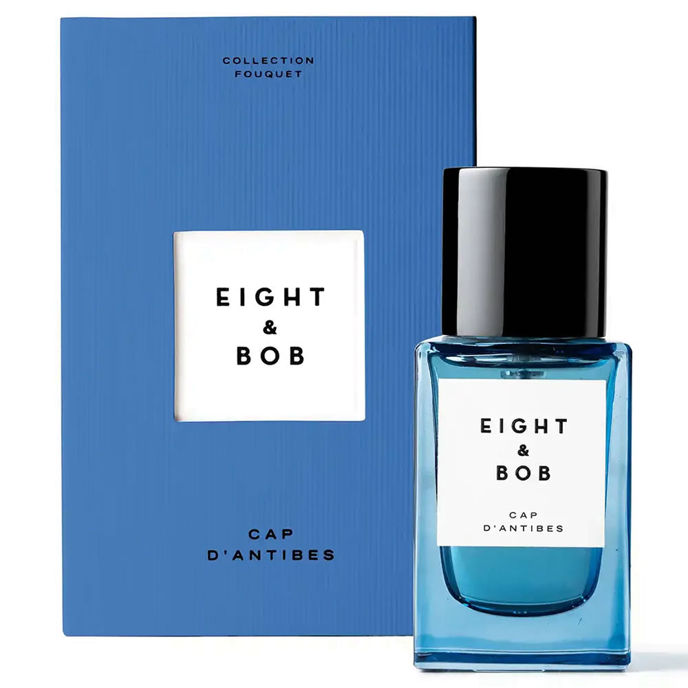 Blue perfume bottle with 'Eight & Bob' label and matching box on a white background