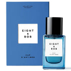Blue perfume bottle with 'Eight & Bob' label and matching box on a white background
