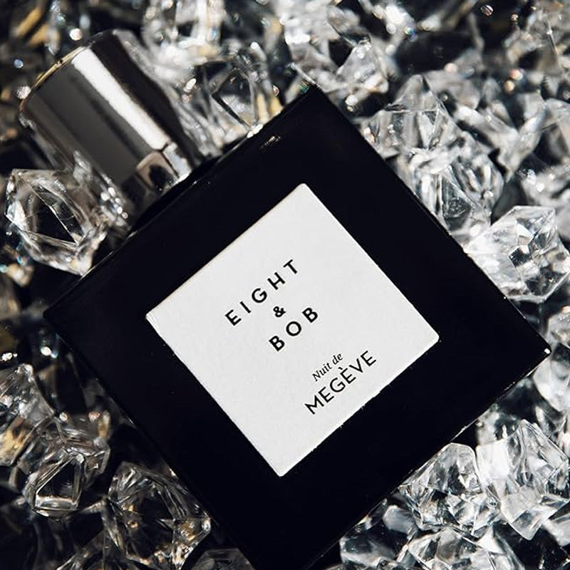 Perfume bottle labeled 'Eight & Bob' on a bed of clear crystals