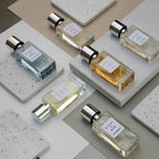 Five small 30ml perfume bottles on a light gray surface with a neutral background