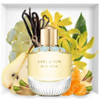 Elie Saab Girl of Now perfume bottle with vanilla beans, pear, and orange in the background