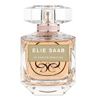 A glass bottle of Elie Saab Le Parfum Essentiel eau de parfum with a pink cap and label.