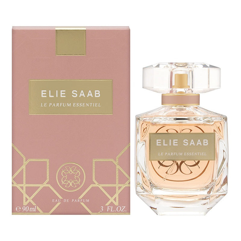 A product image featuring a pink box and a clear bottle of Elie Saab Le Parfum Essentiel Eau De Parfum with a gold cap. The packaging has gold geometric patterns.