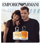 Two people with Emporio Armani perfume bottles and branding.