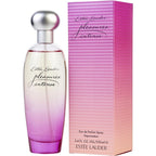 Estee Lauder Pleasures Intense Eau De Parfum Spray bottle and packaging, with a clear glass bottle displaying the pink liquid and a purple to pink gradient design on the box.