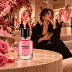 A gallery curator enjoying an evening reception at a botanical art gallery, surrounded by rose-pink floral installations, glass artwork, cashmere furnishings and warm lighting, with the Fugazzi Cash Flower bottle prominently displayed on a polished pale travertine table.