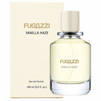 Fugazzi Vanilla Haze 100ml Eau de Parfum clear glass bottle with ivory cap beside its matching cream presentation package featuring Fugazzi branding and black Vanilla Haze lettering on a clean white background.