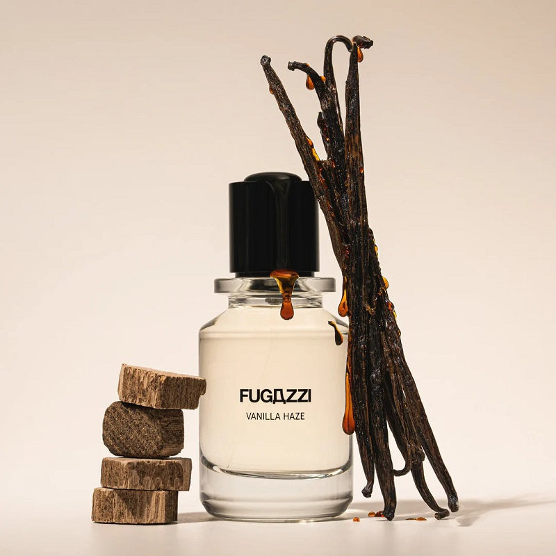 Fugazzi Vanilla Haze perfume bottle with vanilla beans and wooden blocks on a beige background