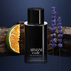 Armani Code perfume bottle with orange, lime, and lavender on a dark background