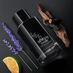 Black Armani Code perfume bottle with lavender, lime, and wood on a dark background