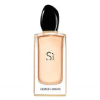 A glass bottle of Armani Sí Eau de Parfum with a black cap, the brand name 'Giorgio Armani' printed on the label, and the scent name 'Sí' visible.