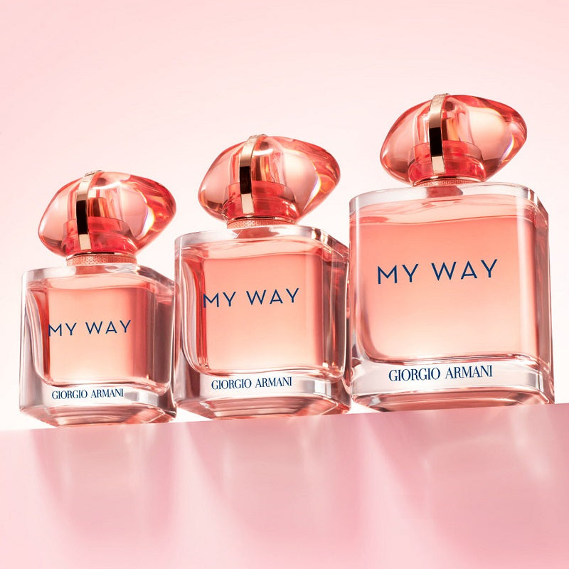 Three bottles of Giorgio Armani 'My Way' perfume on a pink background