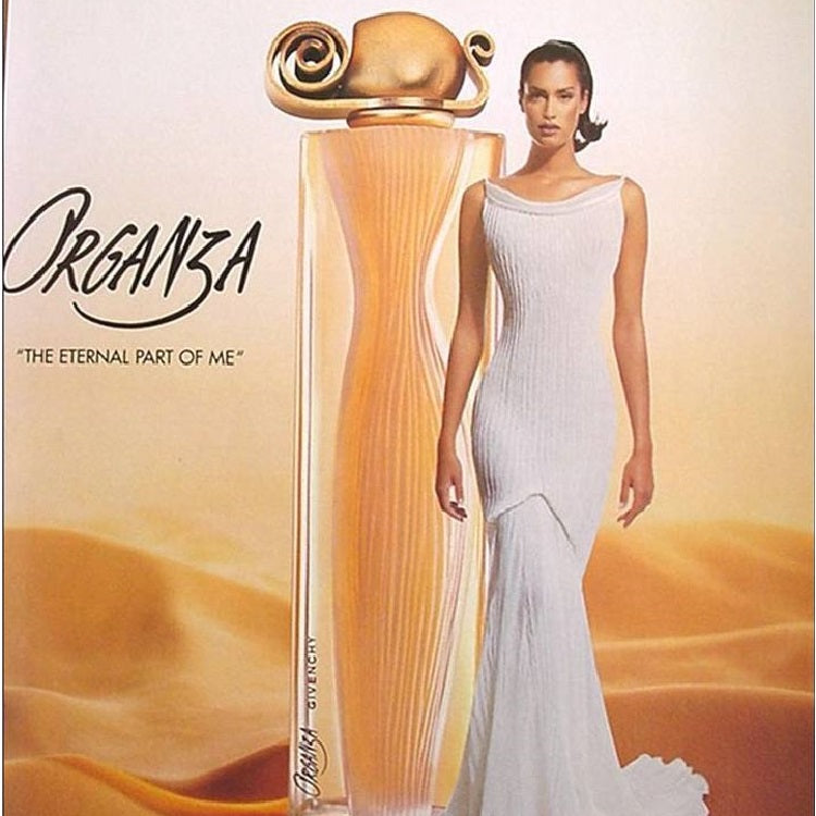 Perfume bottle labeled 'Organza' with a model in a white dress against a desert background
