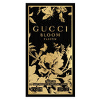 Gucci Bloom parfum packaging with gold floral design on a black background