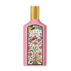 A pink bottle of Gucci Flora Gorgeous Gardenia eau de parfum with a floral pattern on the label.