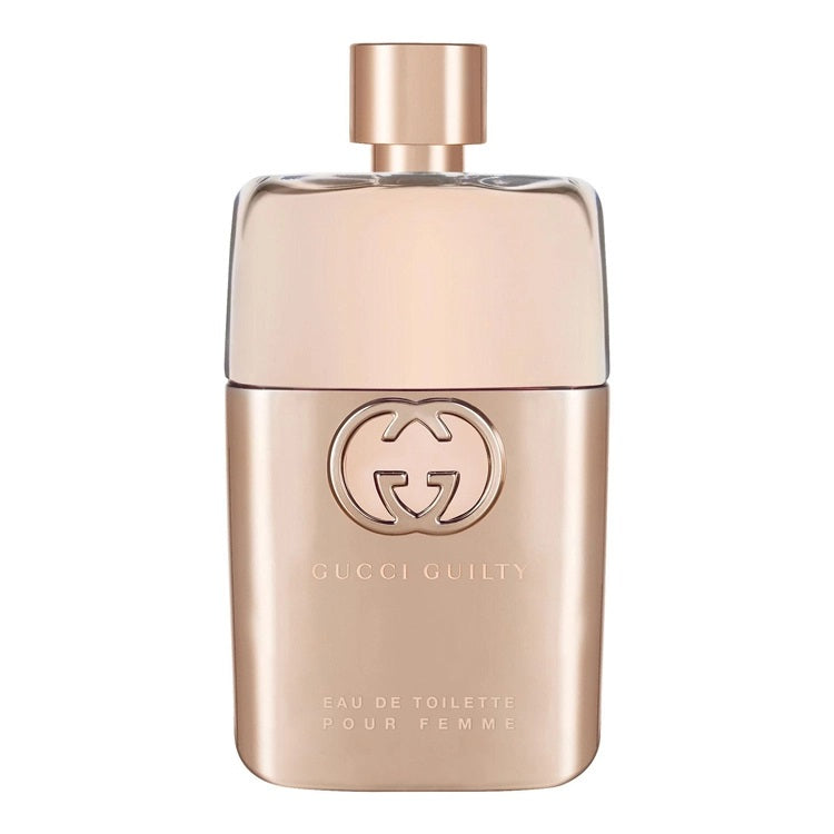 A spray bottle of Gucci Guilty Pour Femme eau de toilette with a gold-colored label and cap.