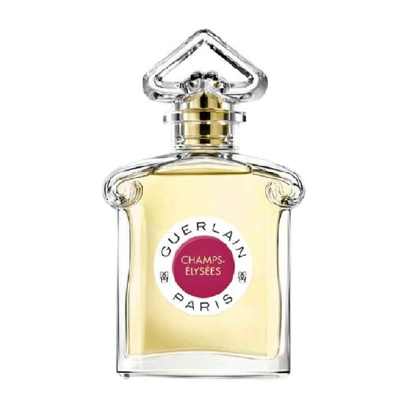 A glass bottle of Champs Elysees Eau de Toilette by Guerlain with a gold and pink label, a clear liquid visible inside, and a decorative cap.