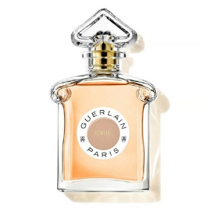 A glass bottle of Guerlain Idylle Eau de Parfum with a gold-colored cap and a label featuring the brand name and fragrance name.