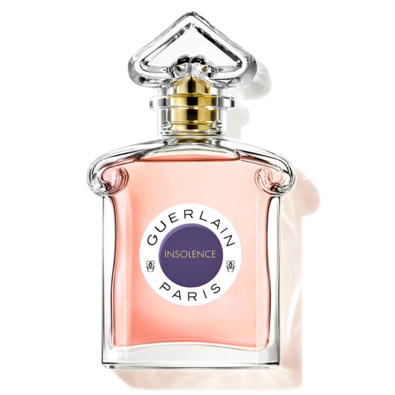 A glass bottle of Insolence Eau de Toilette by Guerlain with a pink liquid visible, labeled with the brand and product name.