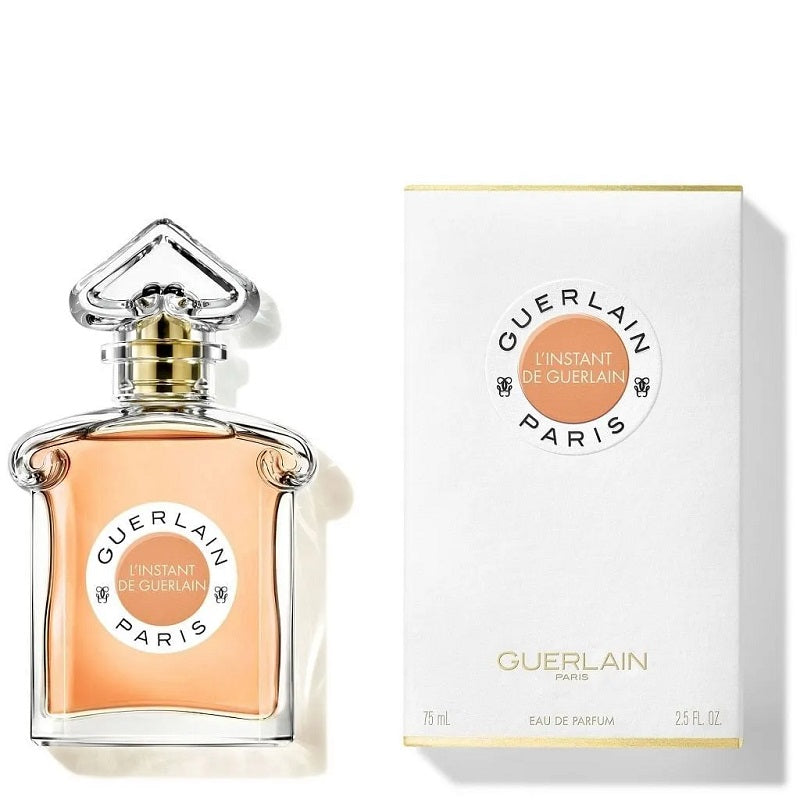 Guerlain L'Instant De Guerlain Eau De Parfum bottle and packaging, featuring the brand name and product title in gold and white design elements against a plain background.